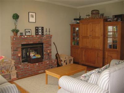 3360 Andy Way Santa Rosa, CA 95404 - Photo 7 of 12 Family room with hardwood flooring, brick fireplace and crown molding
