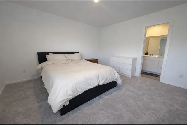 a bedroom with a bed and a lamp