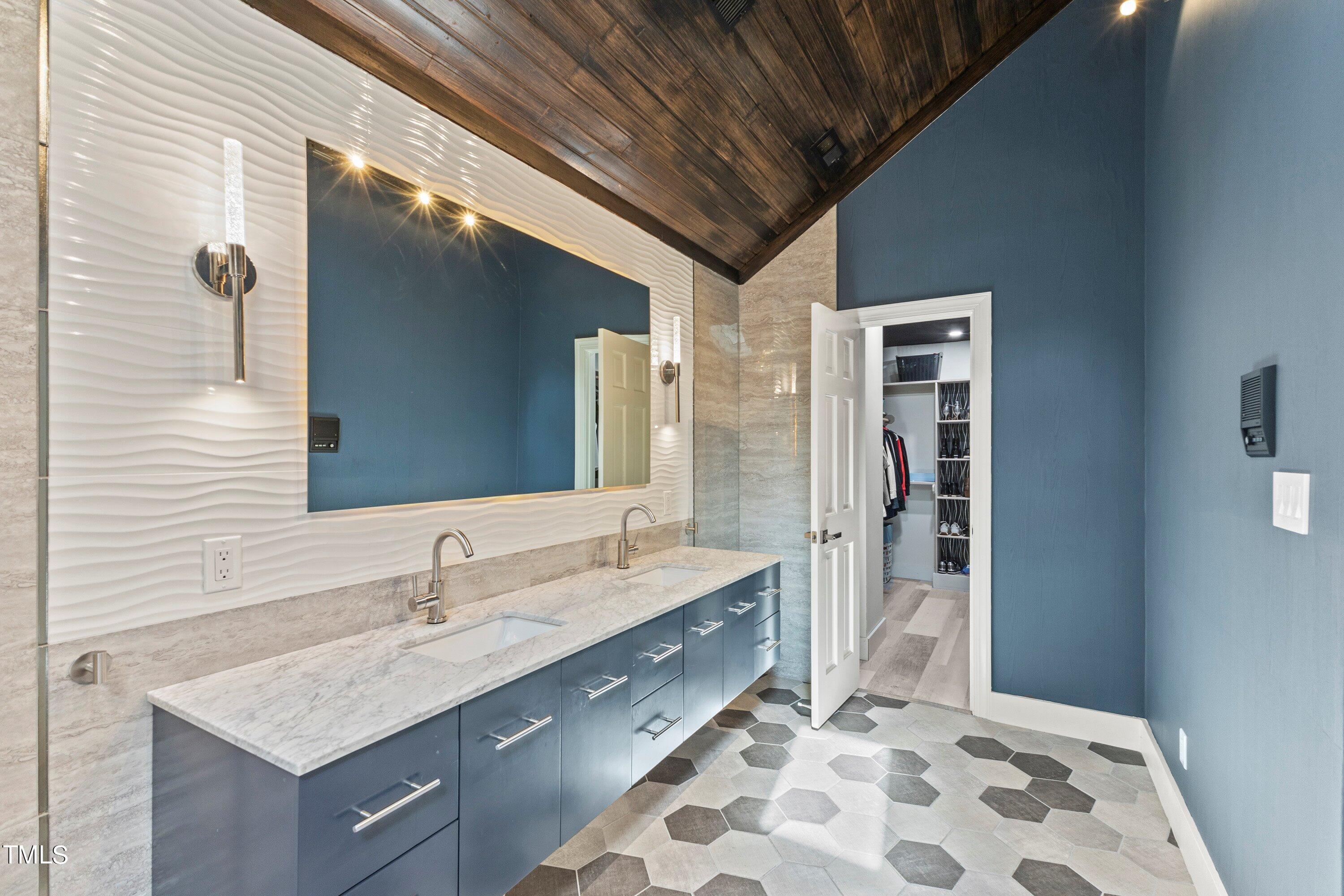 6204 Trevor Court Raleigh, NC 27613 - Photo 43 of 68 a bathroom with a double vanity sink mirror and shower