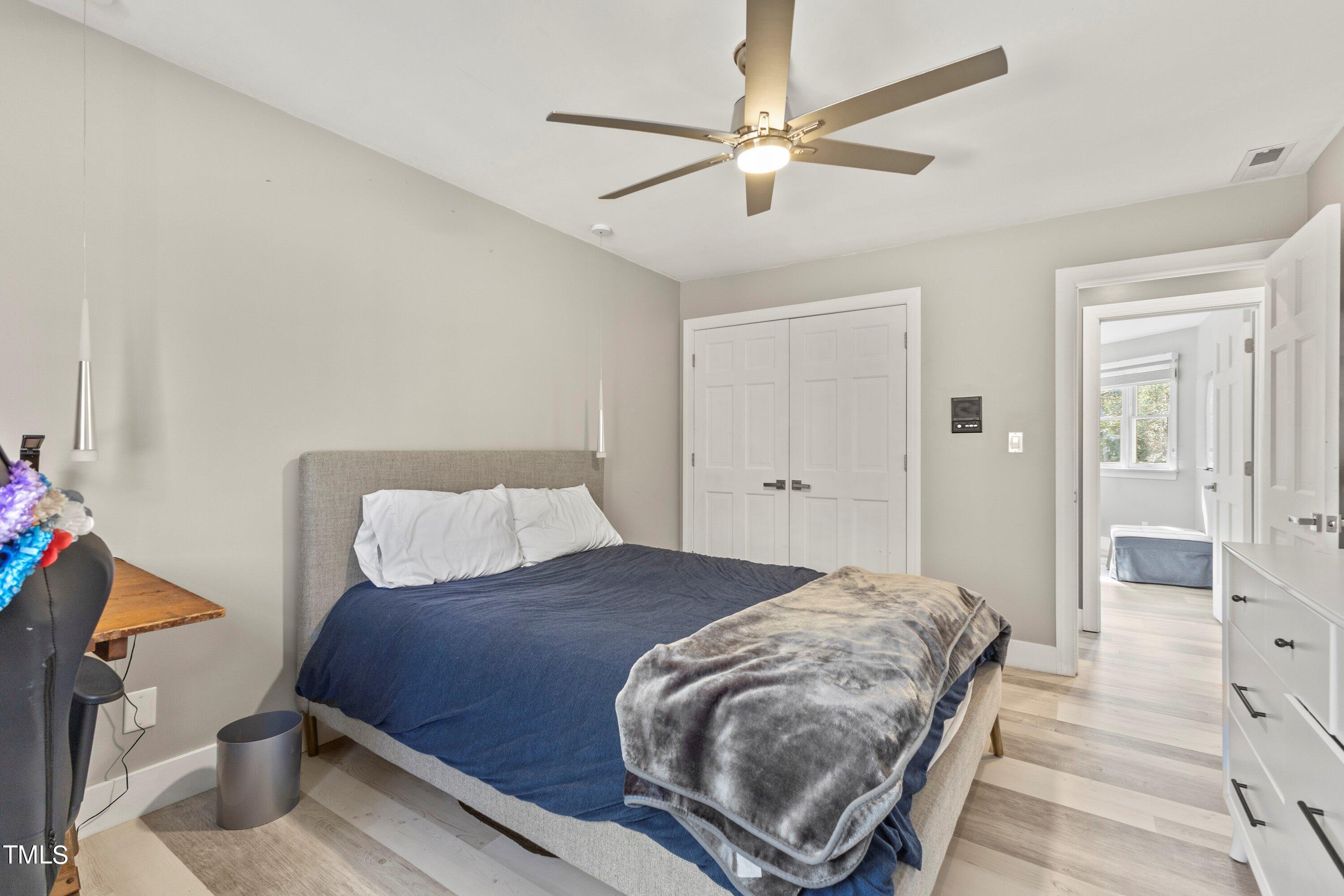 6204 Trevor Court Raleigh, NC 27613 - Photo 53 of 68 a bedroom with a bed and a chandelier
