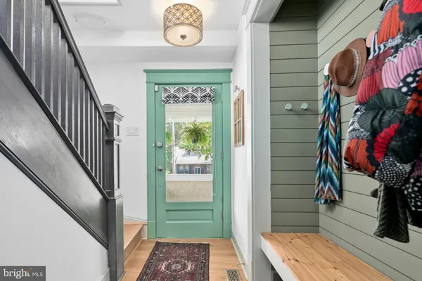 a view of a hallway with wooden floor and staircase