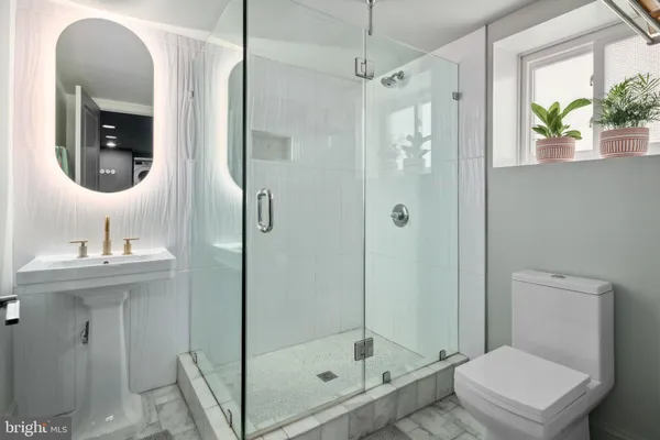 a bathroom with a toilet a sink and a shower