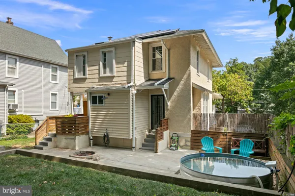 a front view of house with yard outdoor seating and barbeque oven