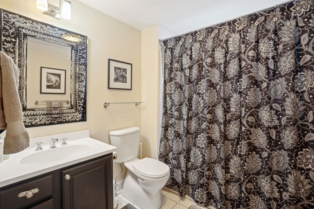 65 Rutherford Avenue Boston, MA 02129 - Photo 13 of 25 a bathroom with a sink a toilet and a mirror