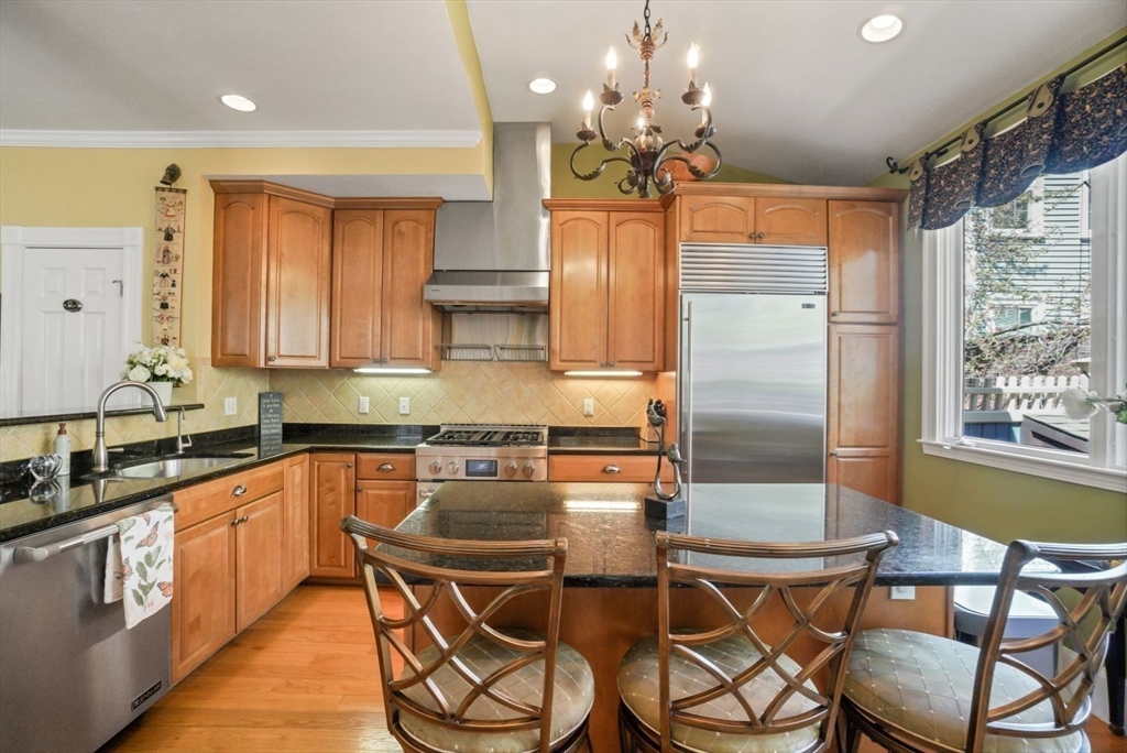 65 Rutherford Avenue Boston, MA 02129 - Photo 5 of 25 a kitchen with stainless steel appliances a table and chairs in it