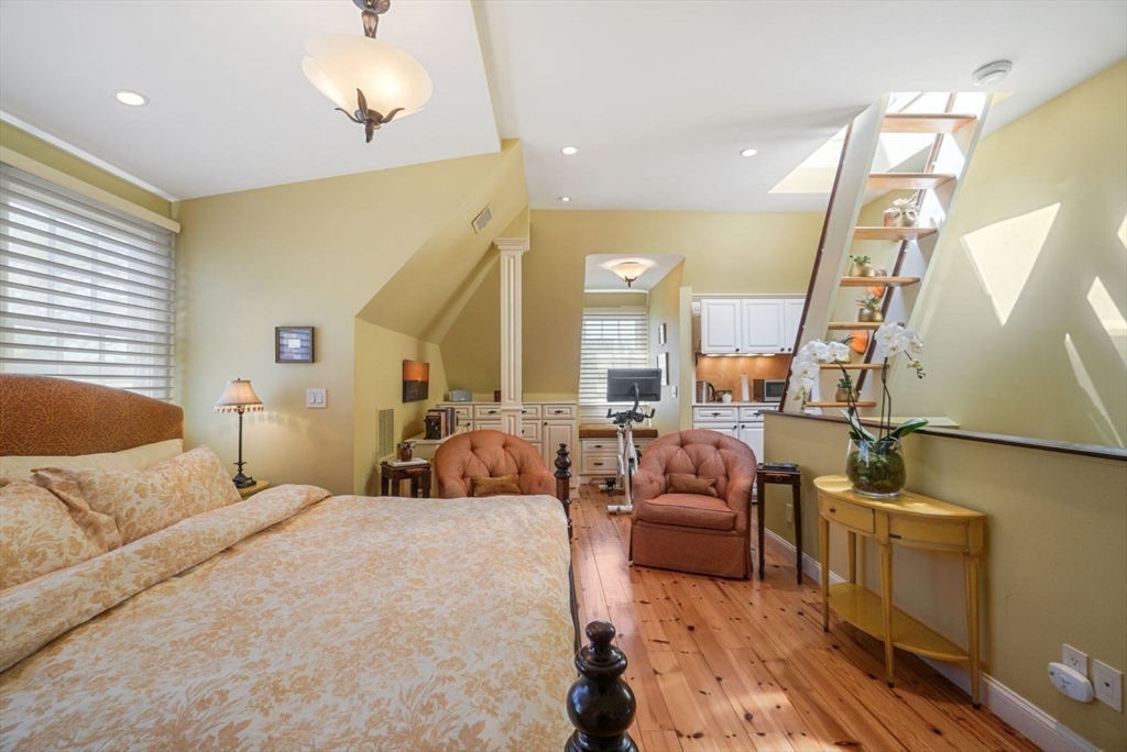 65 Rutherford Avenue Boston, MA 02129 - Photo 8 of 25 a large bedroom with a bed and wooden floor