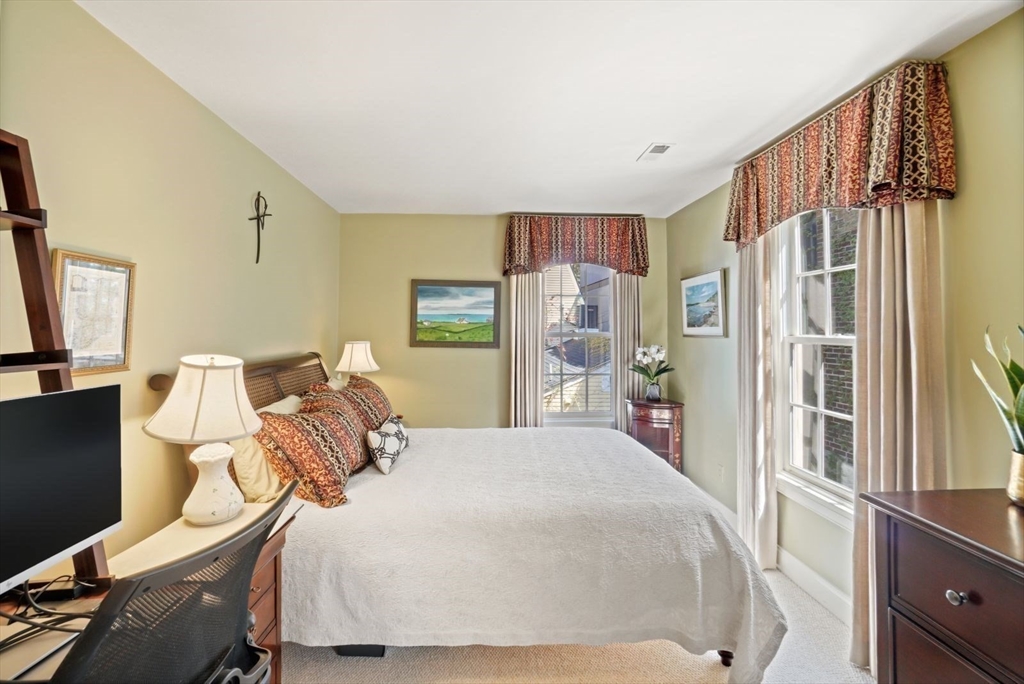 65 Rutherford Avenue Boston, MA 02129 - Photo 10 of 25 a bedroom with a bed and a flat tv screen