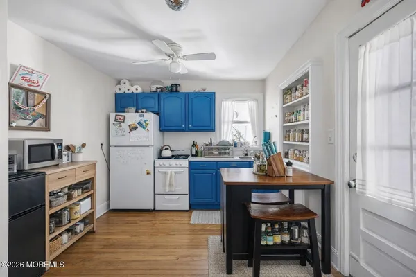 a kitchen with cabinets appliances and a window