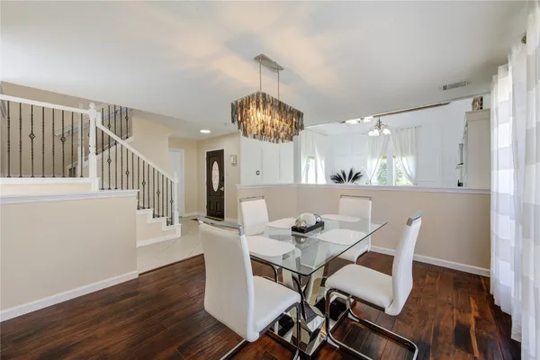 a view of a dining room with furniture wooden floor and chandelier