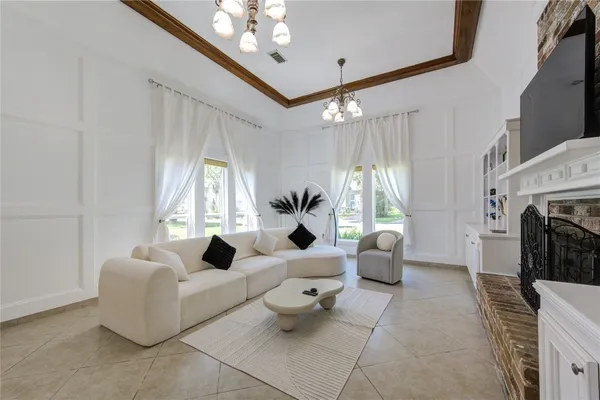 a living room with furniture fireplace and flat screen tv