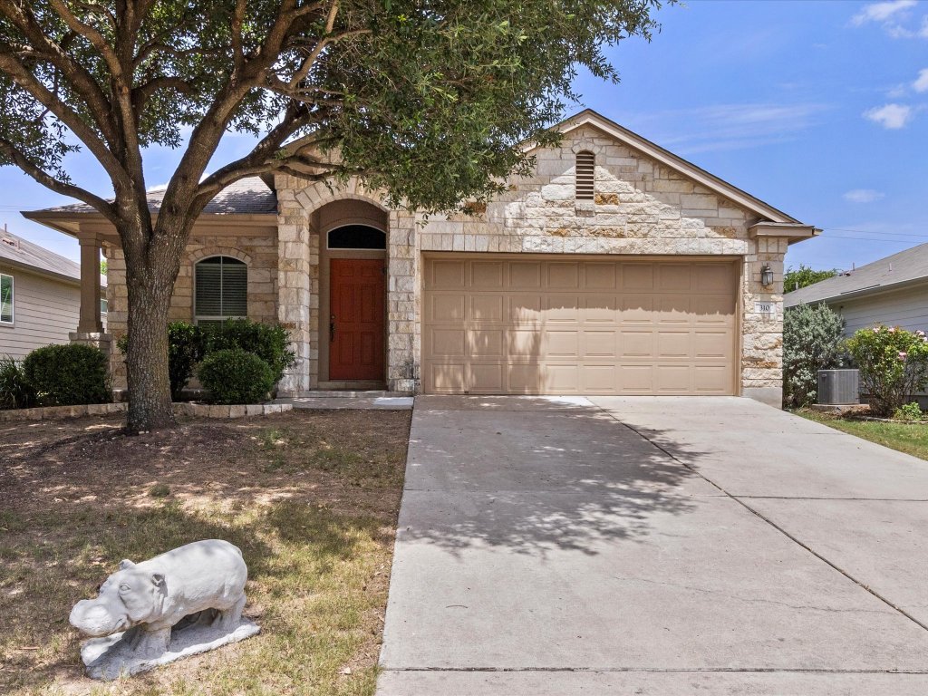 310 Comal Run Hutto, TX 78634 - Photo 1 of 1 a front view of a house with a yard
