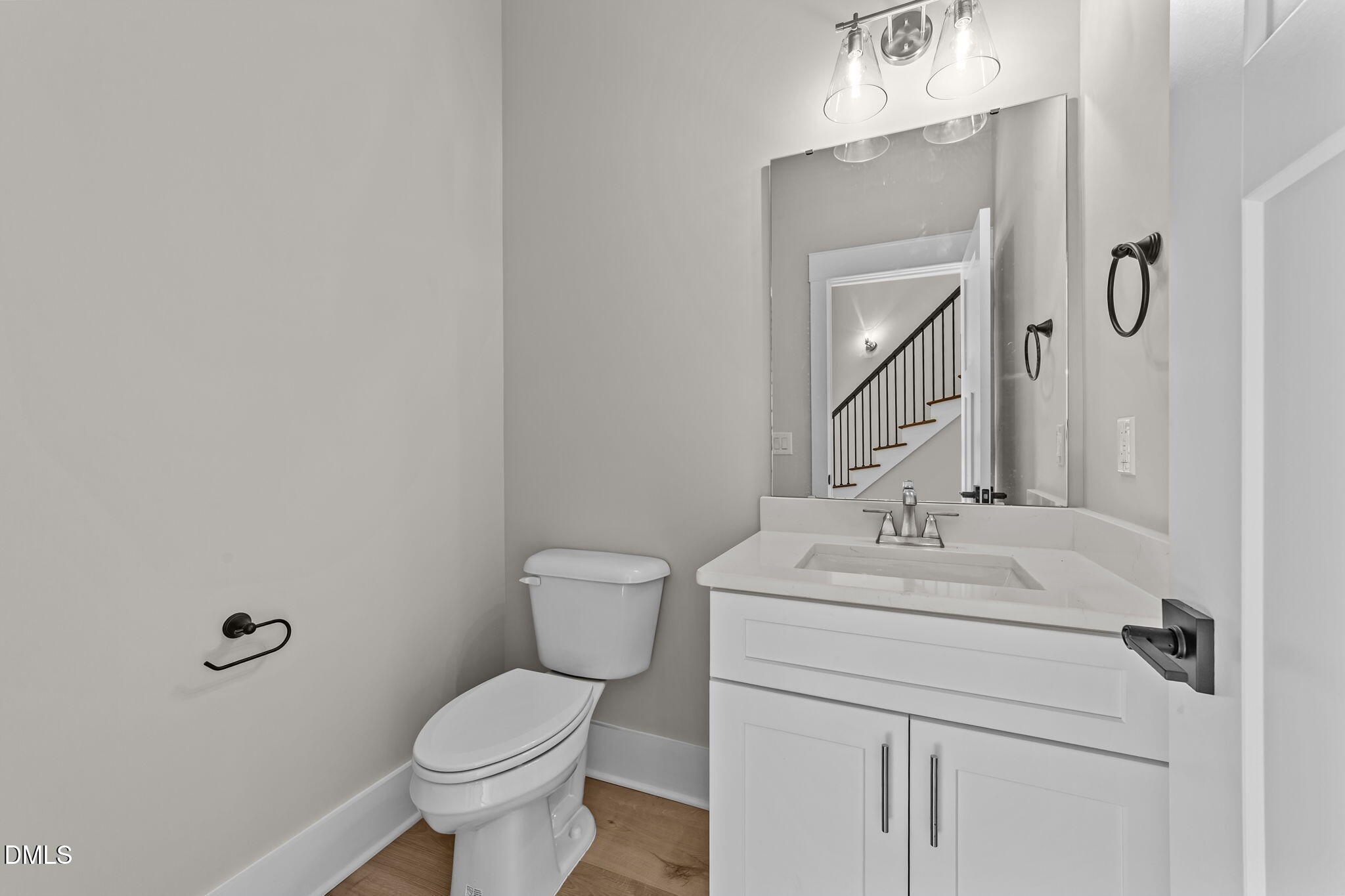 2568 Lassiter Road Four Oaks, NC 27524 - Photo 17 of 45 a bathroom with a toilet sink and mirror