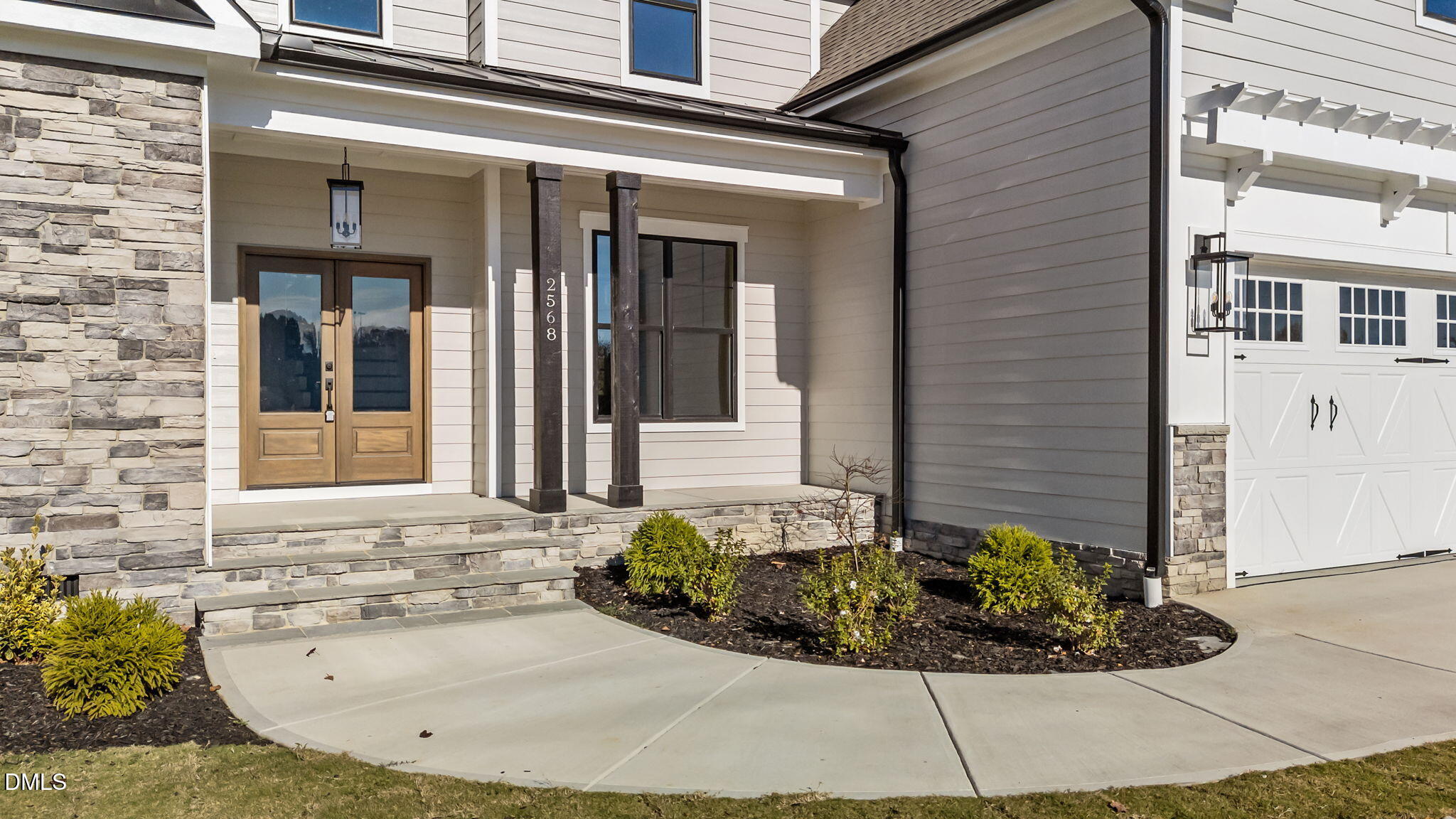 2568 Lassiter Road Four Oaks, NC 27524 - Photo 4 of 45 a view of a brick house with potted plants