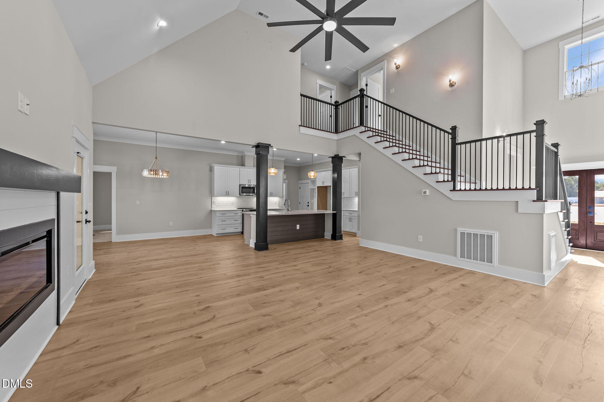2568 Lassiter Road Four Oaks, NC 27524 - Photo 6 of 45 a view of an empty room and a kitchen with a ceiling fan window