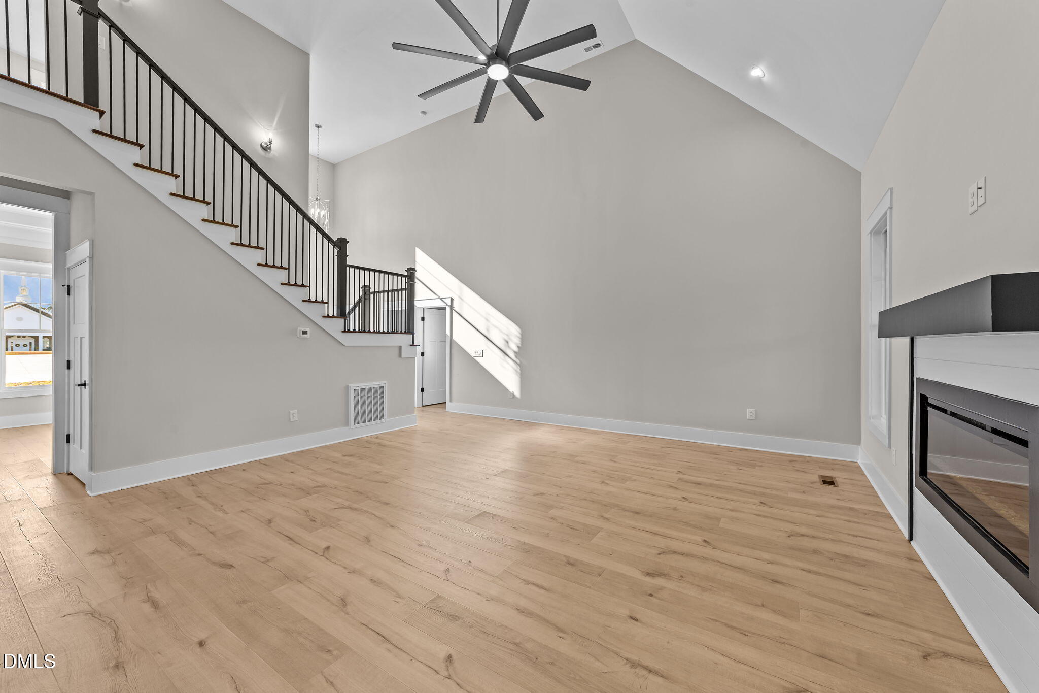 2568 Lassiter Road Four Oaks, NC 27524 - Photo 7 of 45 a view of a livingroom with wooden floor and staircase