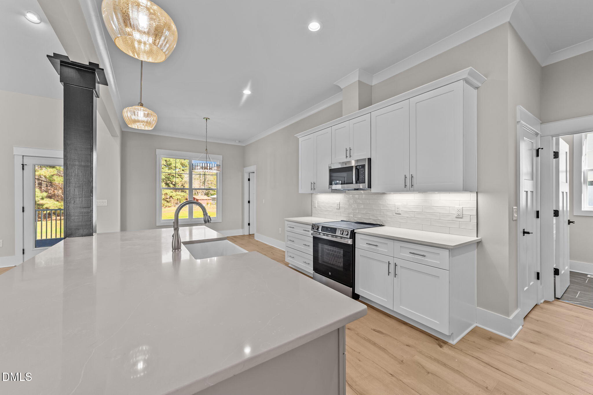 2568 Lassiter Road Four Oaks, NC 27524 - Photo 10 of 45 a kitchen with stainless steel appliances granite countertop a sink a stove and a refrigerator