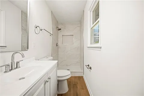 a bathroom with a sink toilet and shower