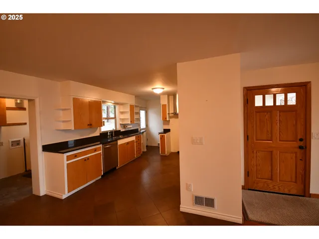 a kitchen with stainless steel appliances granite countertop a refrigerator and a stove