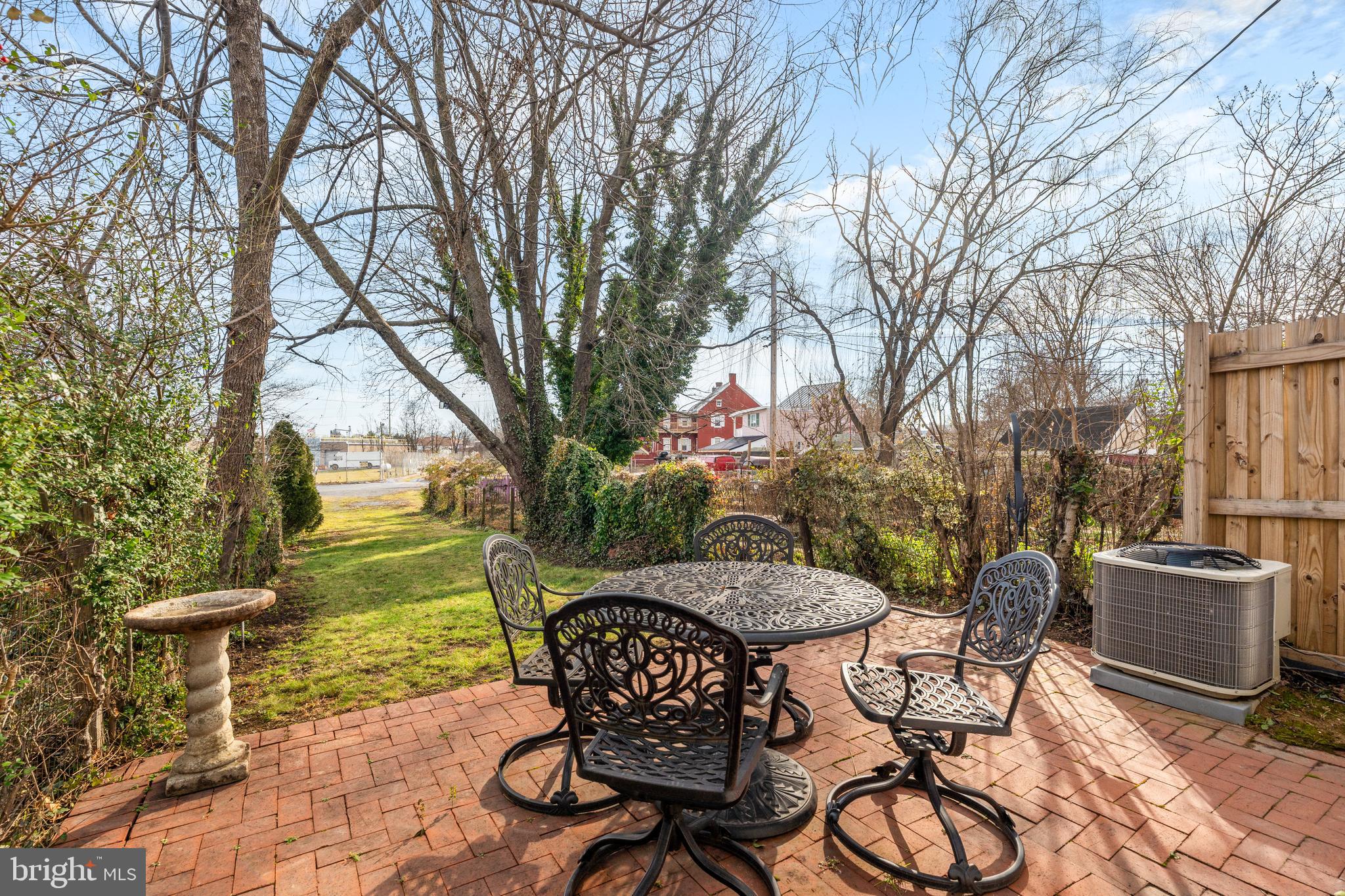 338 East Church Street Frederick, MD 21701 - Photo 28 of 54 a view of a patio with table and chairs and potted plants with large trees