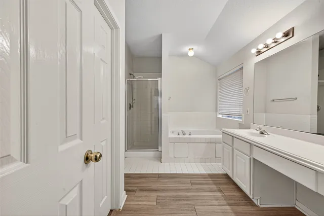 a spacious bathroom with a tub shower and sink
