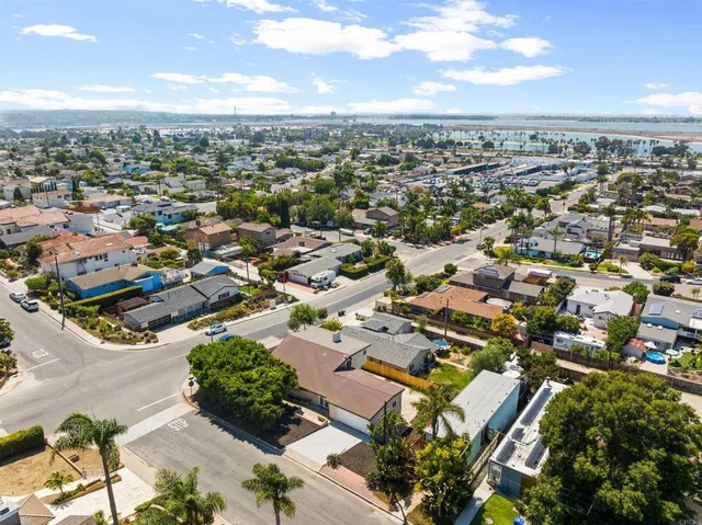 an aerial view of residential houses with city view