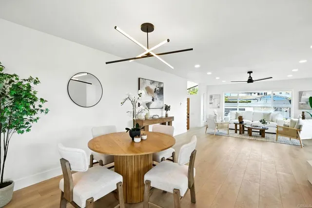 a dining room with furniture and a mirror