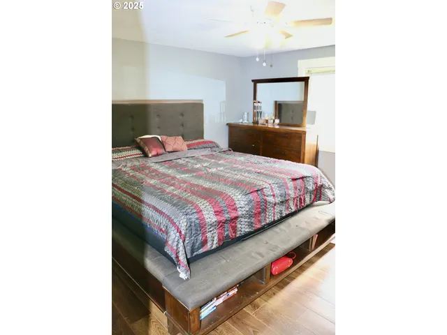 a bedroom with a bed and a mirror