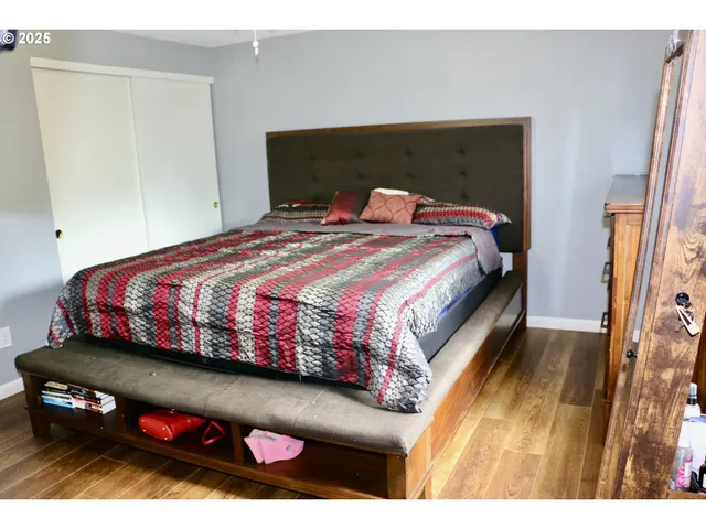 a bedroom with a bed and a dresser