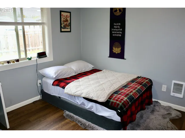 a bedroom with a bed and a window