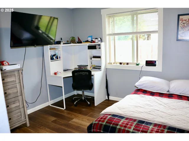 a bedroom with a bed and a flat screen tv