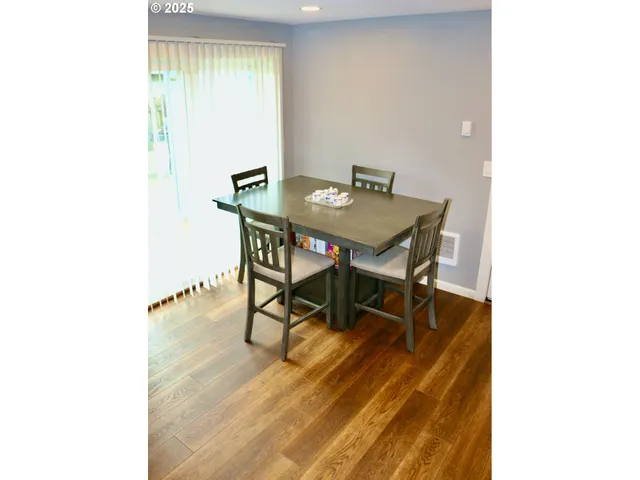 a view of a room with table and chairs