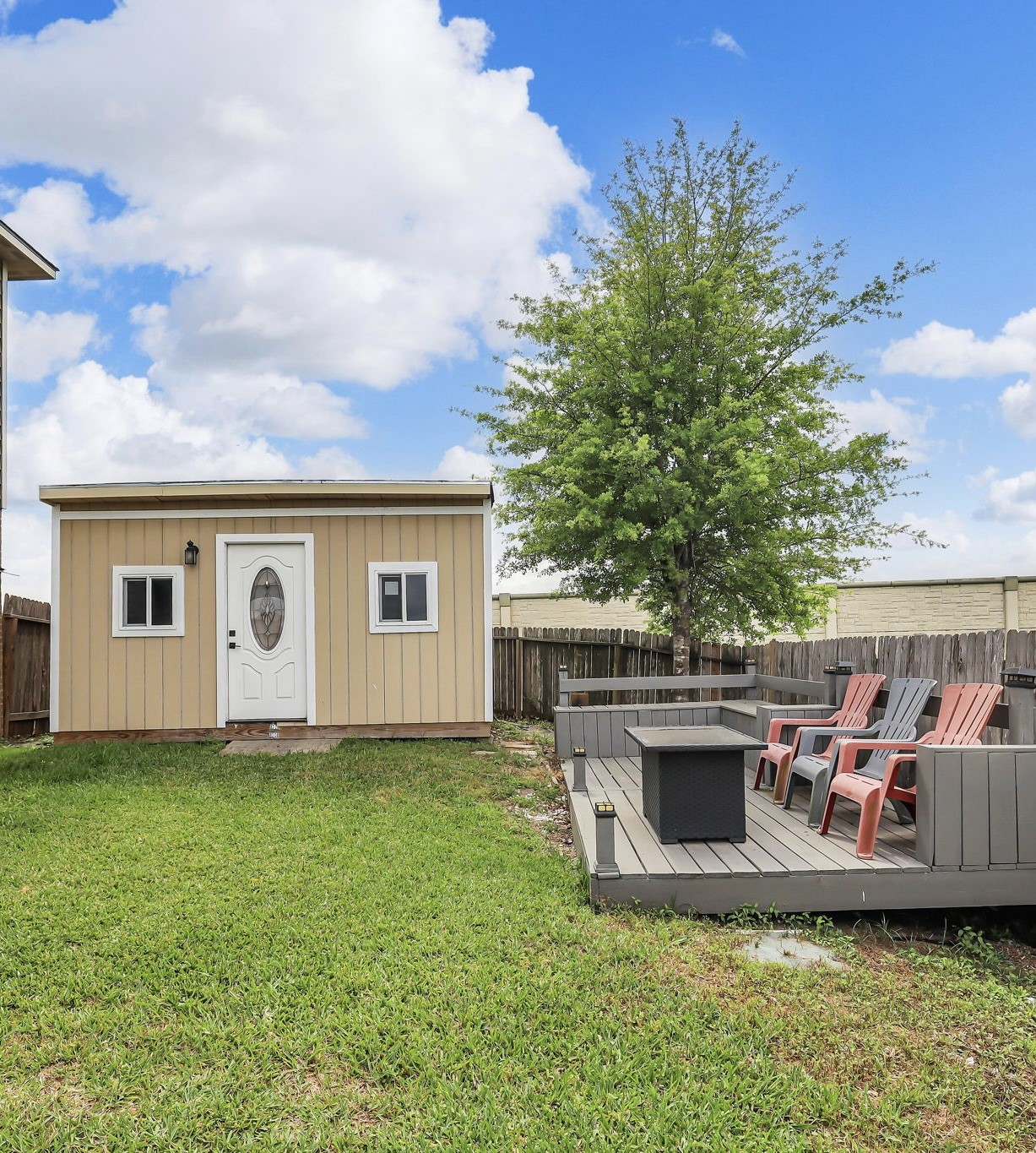 21307 Carleen Creek Trail Spring, TX 77379 - Photo 22 of 25 Backyard has a small shed, a portable building and is fenced for privacy. Features a cozy deck with seating and a fire pit, perfect for outdoor gatherings.