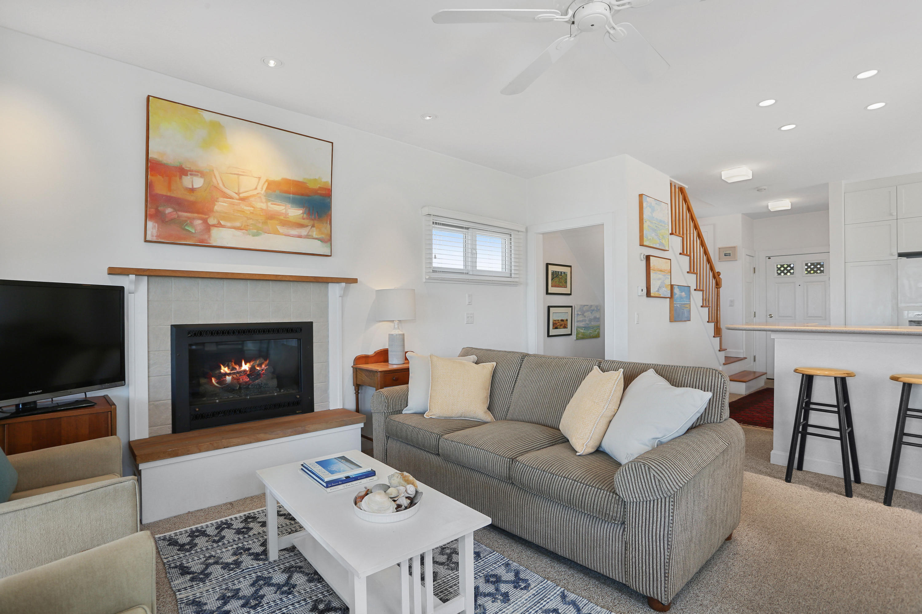 137 Nauhaught Bluff Road Wellfleet, MA 02667 - Photo 16 of 33 a living room with furniture a flat screen tv and a fireplace