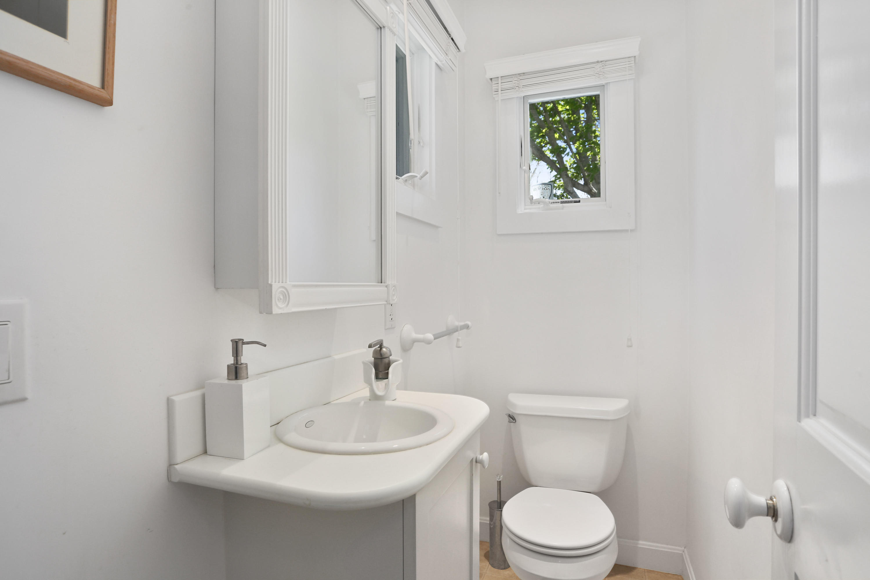 137 Nauhaught Bluff Road Wellfleet, MA 02667 - Photo 18 of 33 a bathroom with a toilet a sink and a window