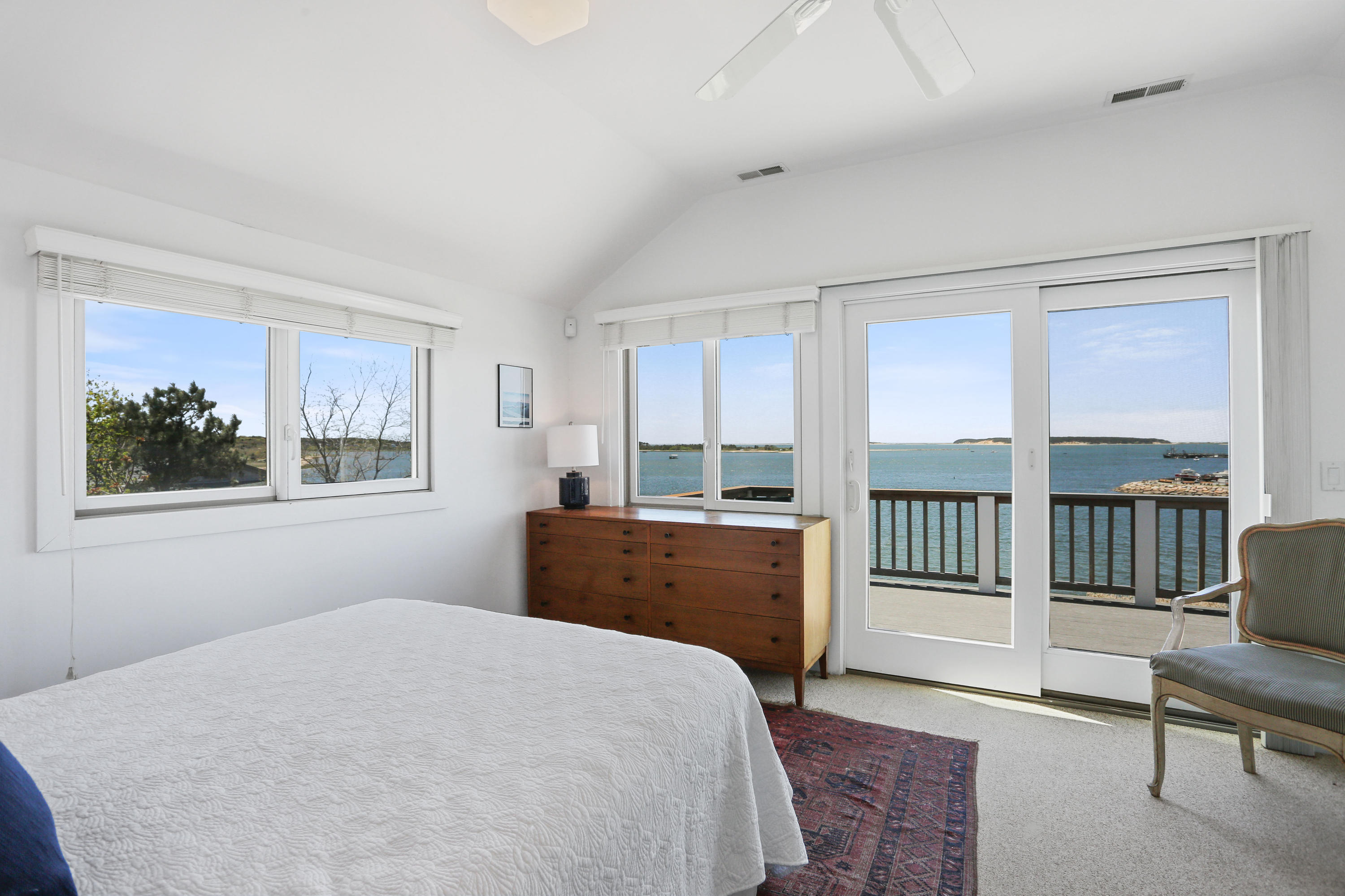 137 Nauhaught Bluff Road Wellfleet, MA 02667 - Photo 19 of 33 a bedroom with a large bed and a large window