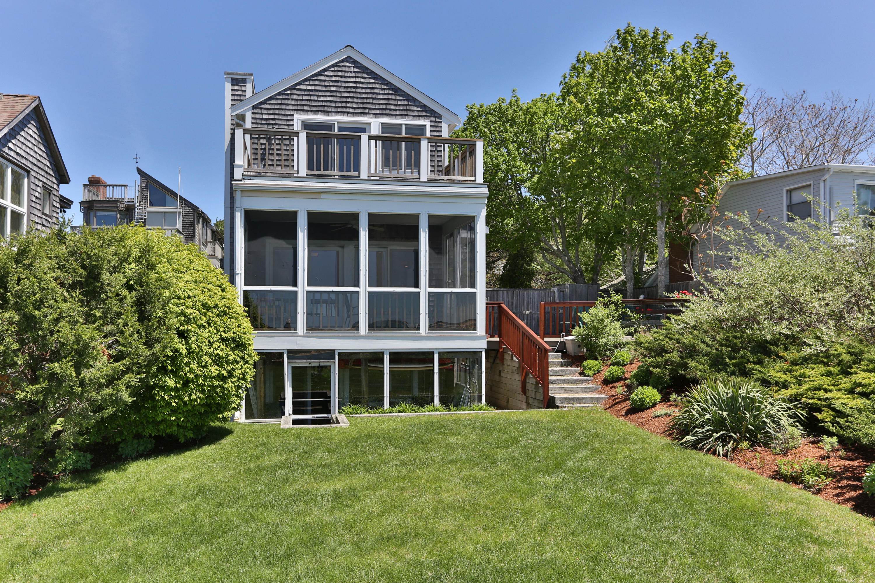 137 Nauhaught Bluff Road Wellfleet, MA 02667 - Photo 2 of 33 a front view of a house with a yard