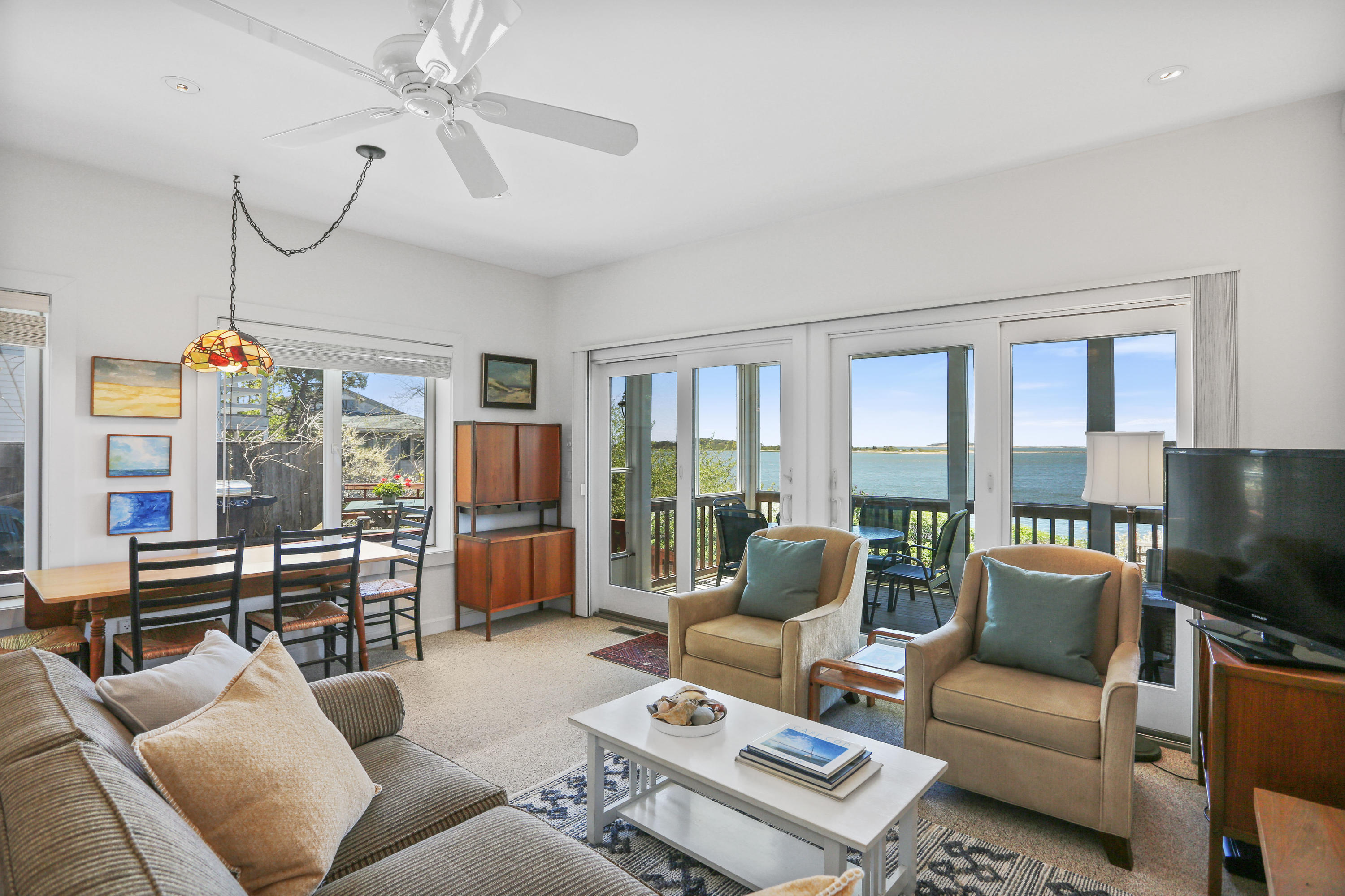 137 Nauhaught Bluff Road Wellfleet, MA 02667 - Photo 10 of 33 a living room with furniture ceiling fan and a window