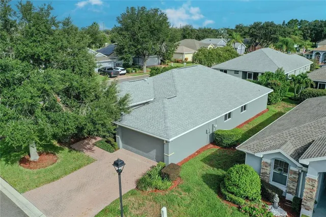 an aerial view of a house with a yard