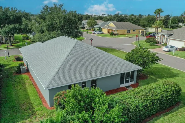 an aerial view of a house with a yard and lake view