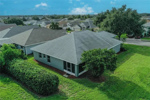 an aerial view of a house with a yard