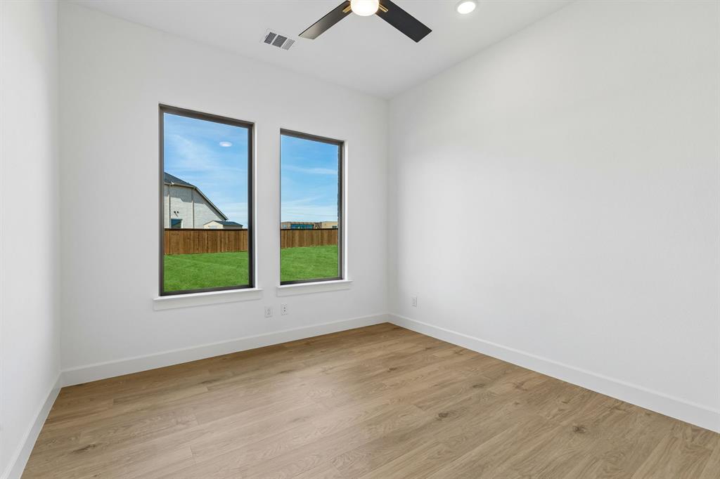 15852 Amber Street Frisco, TX 75033 - Photo 12 of 19 an empty room with a window and a ceiling fan