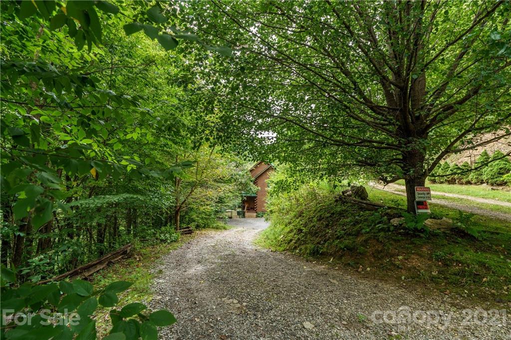 181 Lonesome Pines Road, Unit 69 Clyde, NC 28721 - Photo 22 of 26 a big yard with lots of green space and house