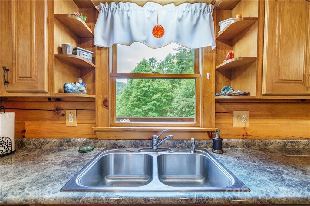 181 Lonesome Pines Road, Unit 69 Clyde, NC 28721 - Photo 8 of 26 a kitchen sink with a granite countertop window and sink
