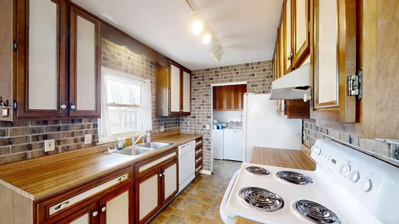 1002 Goldenview Drive Champaign, IL 61821 - Photo 12 of 38 a kitchen with a sink a stove and a refrigerator