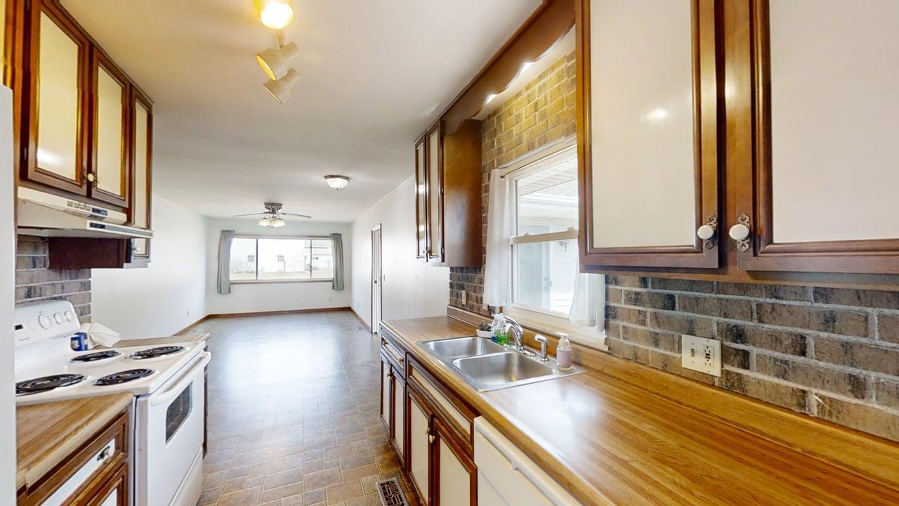 1002 Goldenview Drive Champaign, IL 61821 - Photo 13 of 38 a kitchen with granite countertop a sink stove and cabinets