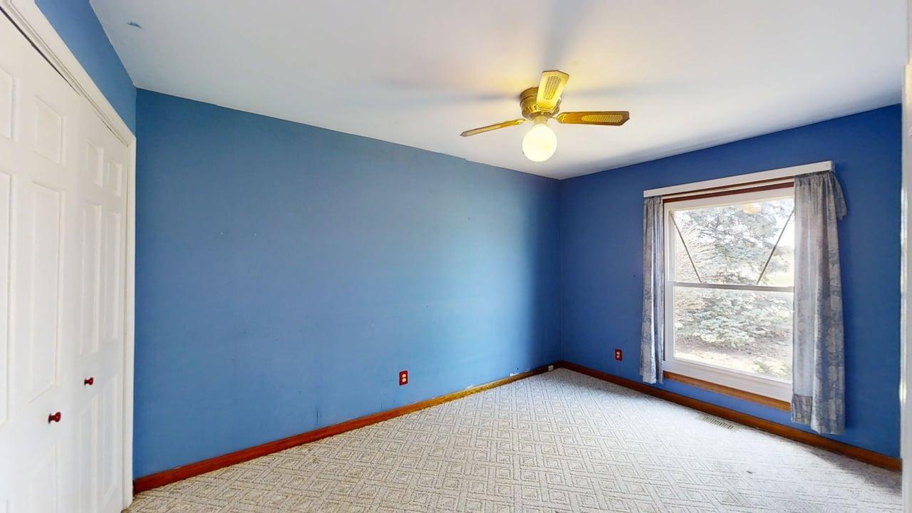 1002 Goldenview Drive Champaign, IL 61821 - Photo 19 of 38 an empty room with a window and ceiling fan