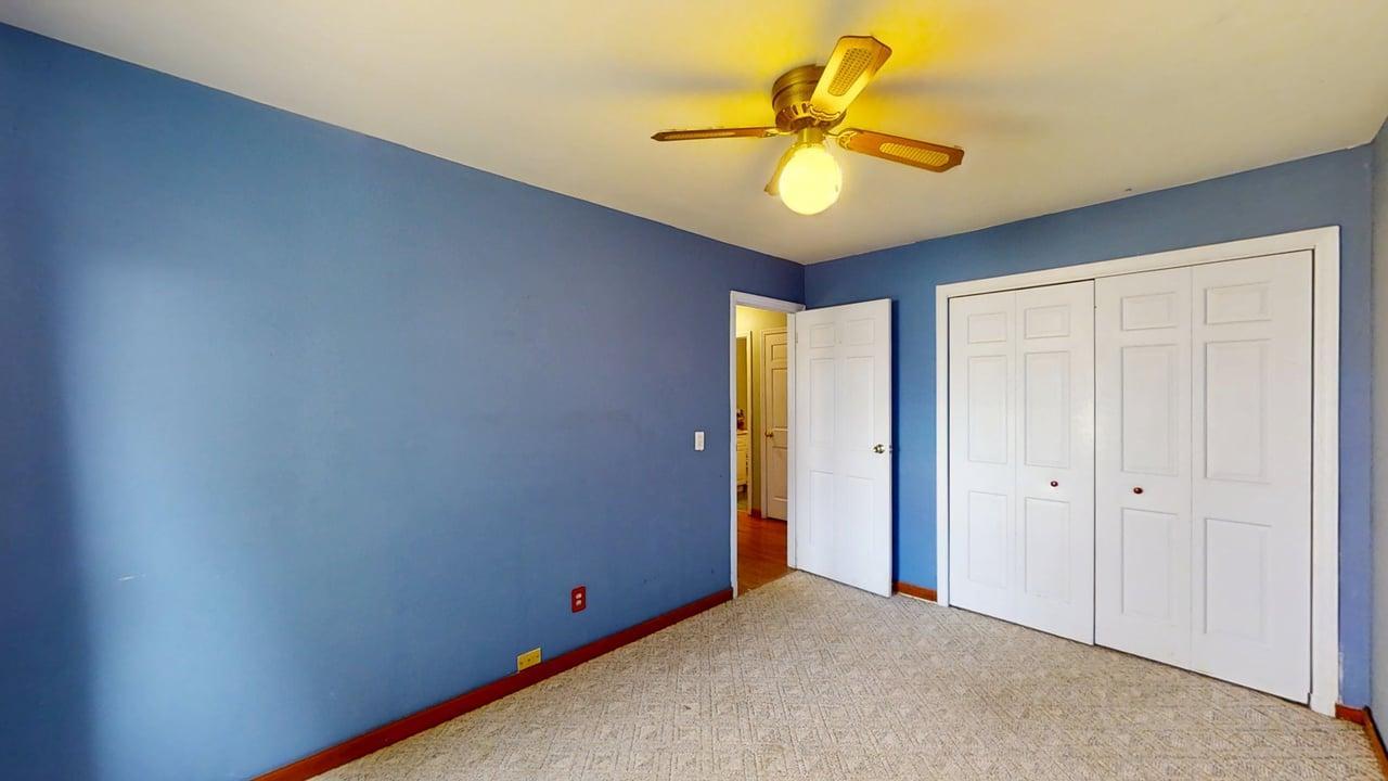 1002 Goldenview Drive Champaign, IL 61821 - Photo 21 of 38 an empty room with a ceiling fan and carpet