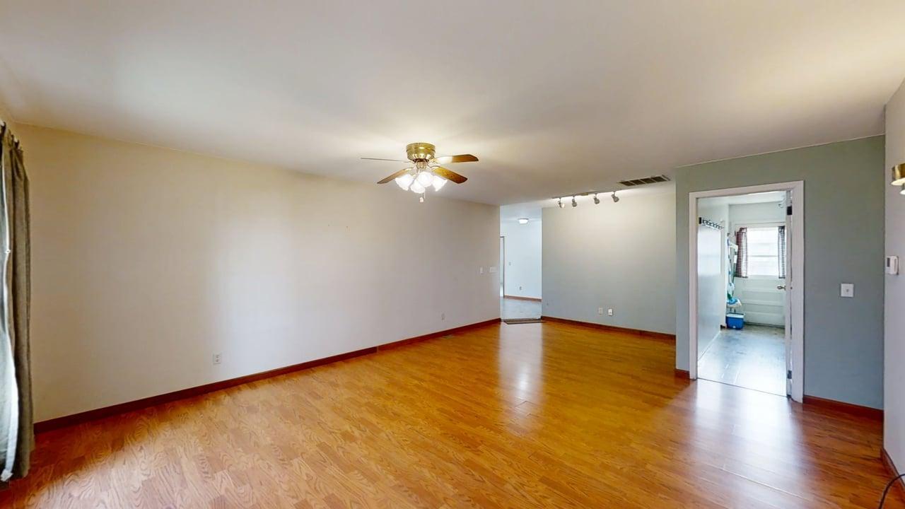 1002 Goldenview Drive Champaign, IL 61821 - Photo 3 of 38 a view of a livingroom with wooden floor and a ceiling fan