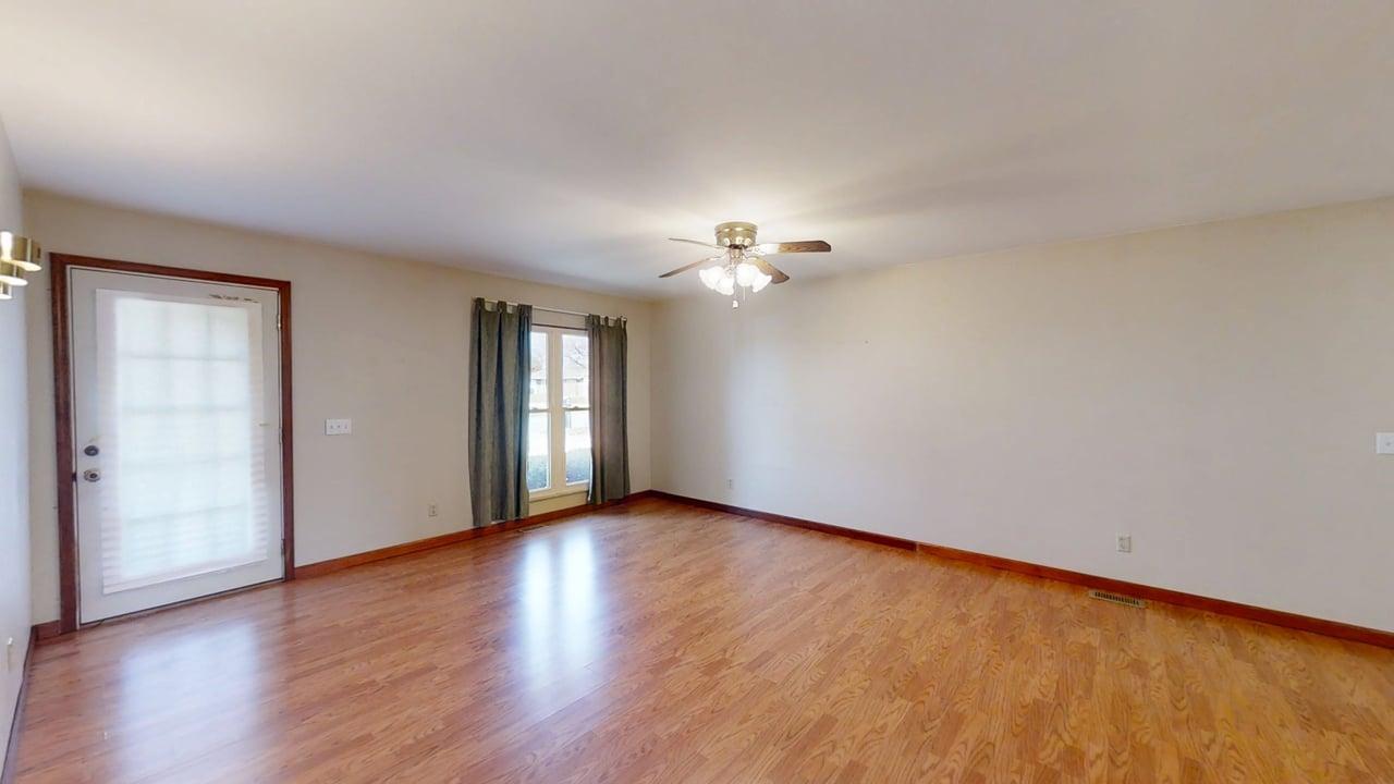 1002 Goldenview Drive Champaign, IL 61821 - Photo 5 of 38 a view of an empty room with wooden floor and window