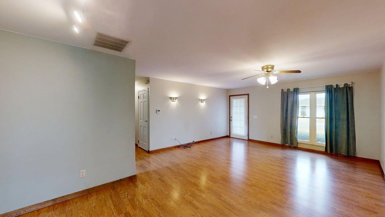 1002 Goldenview Drive Champaign, IL 61821 - Photo 6 of 38 an empty room with wooden floor and window